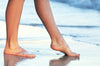 aos skincare image of feet on a beach
